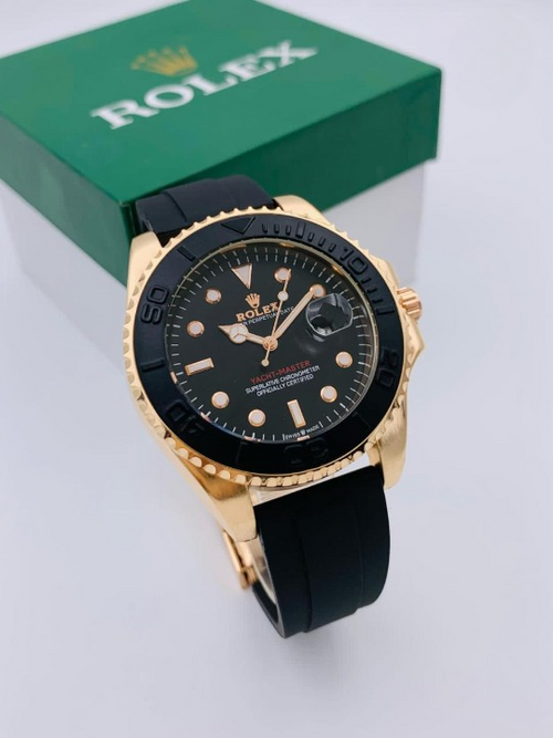 Men's luxury gold case dress watch with black dial and rotating bezel on black rubber strap – front view with green gift box