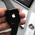 Series 9 smart watch black edition in hand showing Roman numeral luxury watch face on AMOLED display