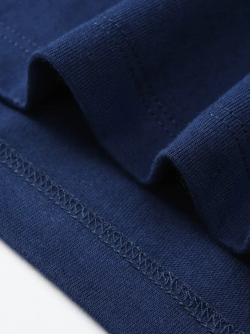 Close up of navy blue premium cotton blend fabric showing high quality double stitch seams and texture detail