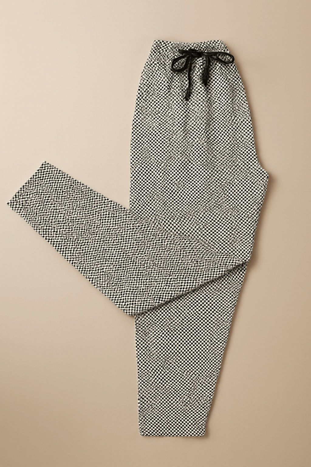 Men's geometric print drawstring trousers on beige background – clean product flat lay