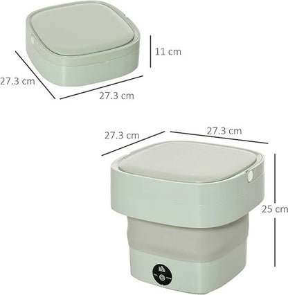 Folding washing machine assembled with box and accessories on wooden table