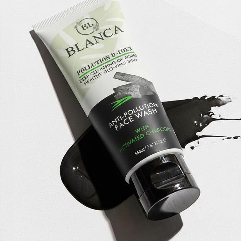 Blanca Pollution D-Toxx Face Wash with charcoal splash on white background dramatic product shot