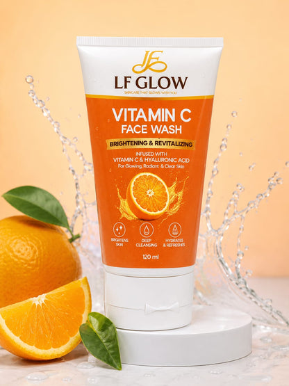 LF Glow Vitamin C Face Wash 120ml tube on white podium with orange slices and water splash on orange background