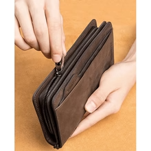 Baellerry Premium Long Leather Wallet in Light Brown and Dark Brown side by side on wooden surface with whiskey bottle – lifestyle product shot