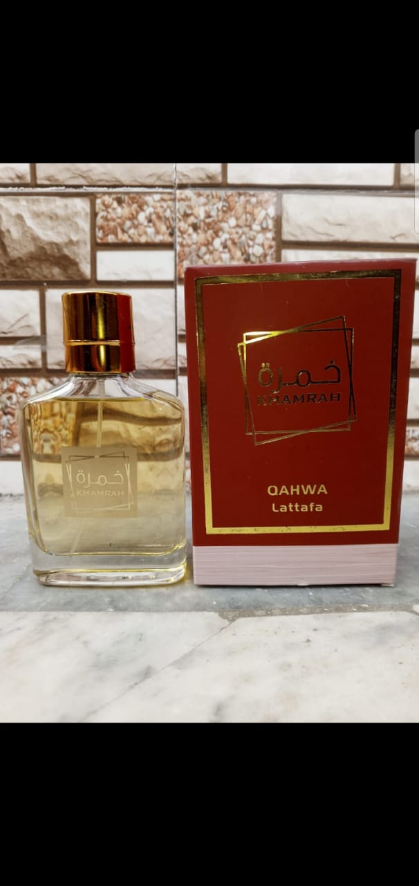 Khamrah Qahwa Lattafa perfume bottle with red box on marble surface