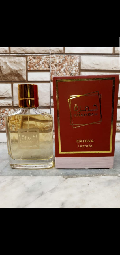 Khamrah Qahwa Lattafa perfume bottle with red box on marble surface