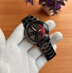Men's spinning wheel dial watch black with red accents held in gloved hand – close up of 3D rim dial