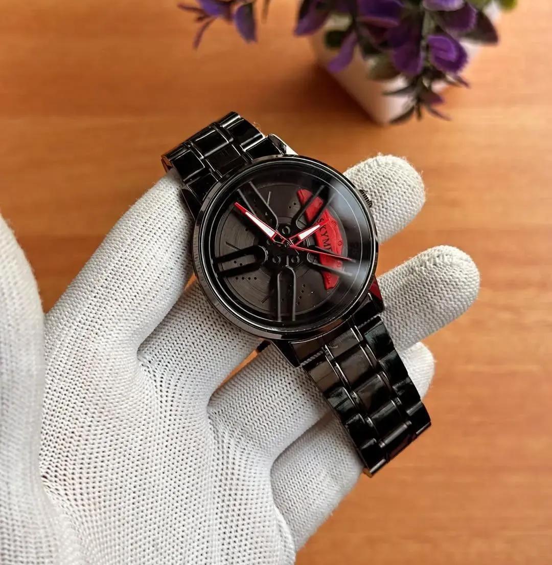 Men's spinning wheel dial watch black with red accents held in gloved hand – close up of 3D rim dial