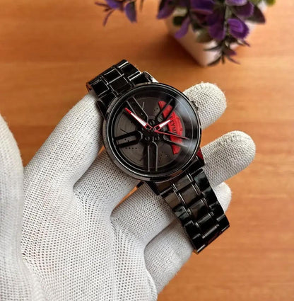 Men's spinning wheel dial watch black with red accents held in gloved hand – close up of 3D rim dial