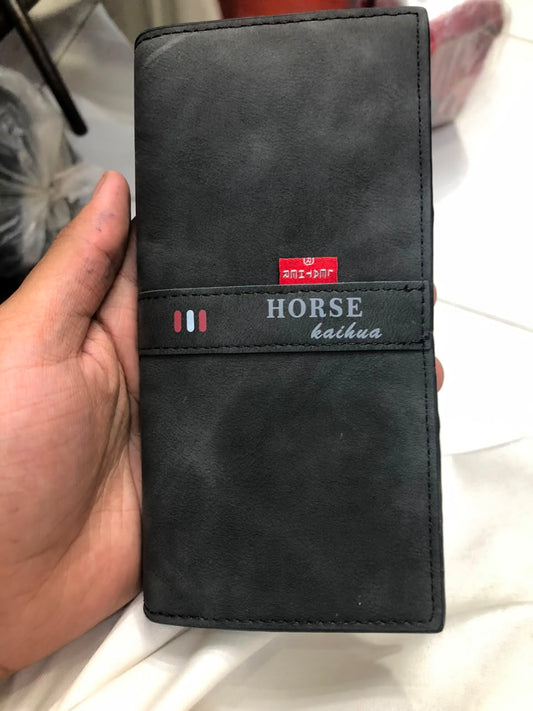 Horse Kaihua long leather wallet in Black held in hand showing front distressed leather texture and branded strap detail