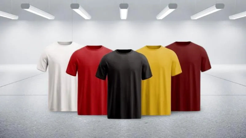 Pack of 5 plain short sleeve round neck t-shirts in White Red Black Yellow Maroon displayed on hangers in studio lighting on grey background