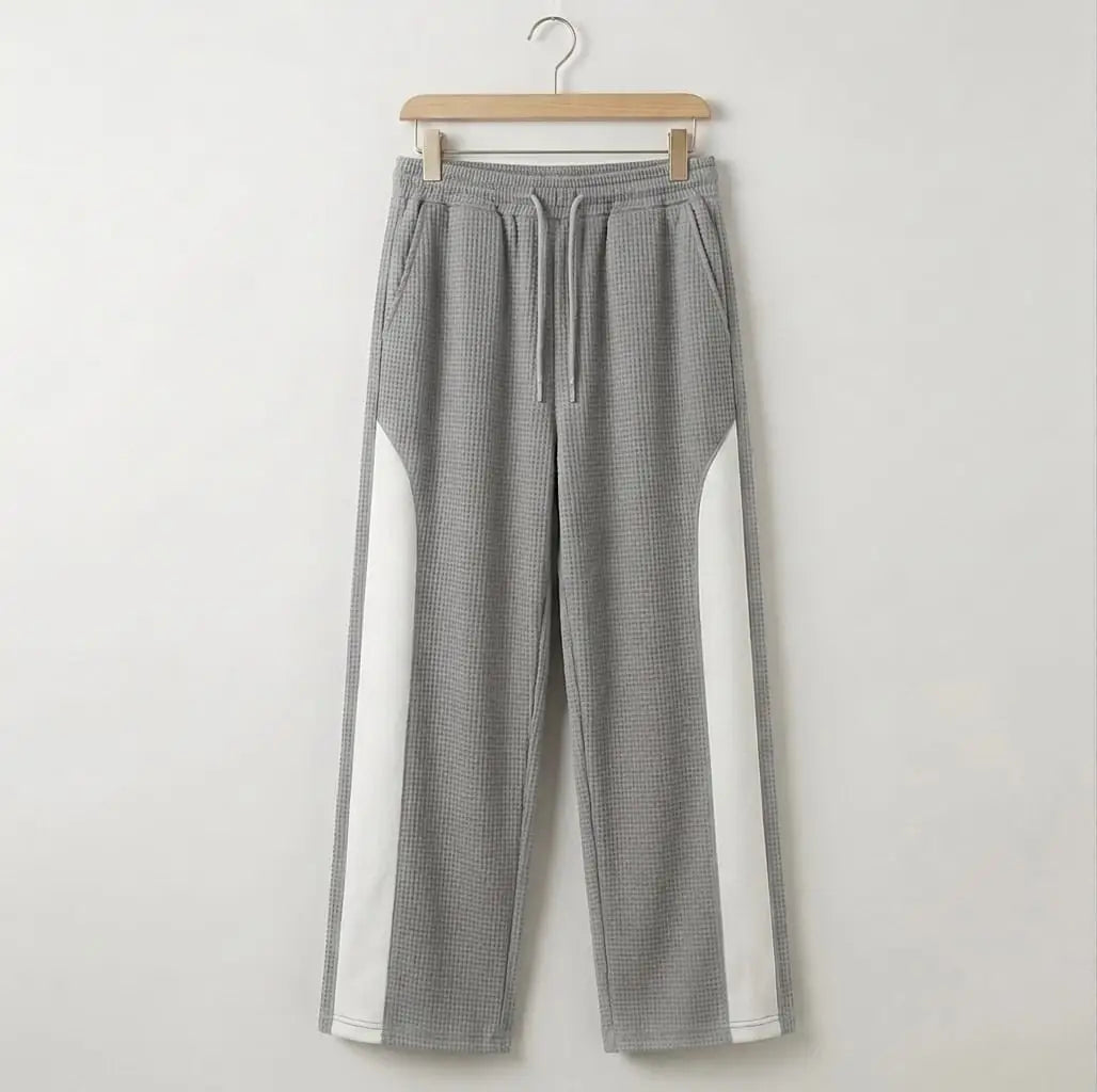 Grey waffle knit white side panel drawstring trousers on wooden hanger – full length front product shot on white background
