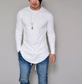 Man wearing white slim fit long sleeve round neck curved hem t-shirt with ripped jeans – front lifestyle model shot on grey background