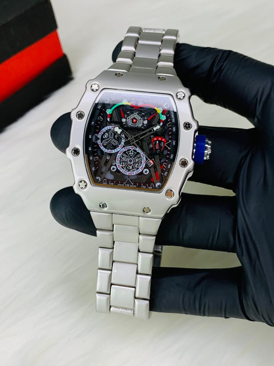 Silver watch with blue crown side view