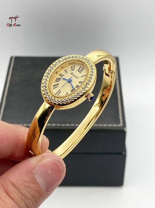 BOMEI gold bangle watch on mirror surface reflection