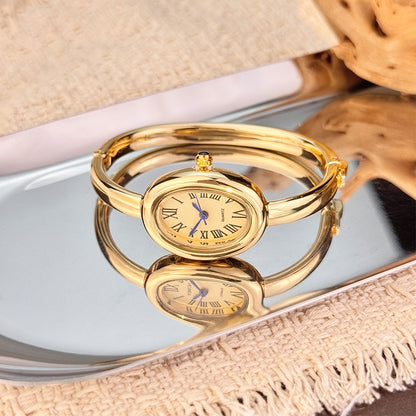 BOMEI gold bangle watch on crystal display