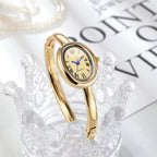 BOMEI gold bangle watch on crystal display side view