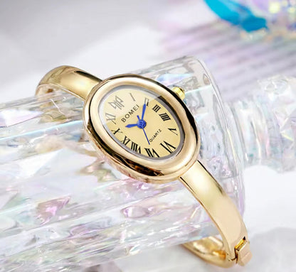 BOMEI gold bangle watch close up dial view