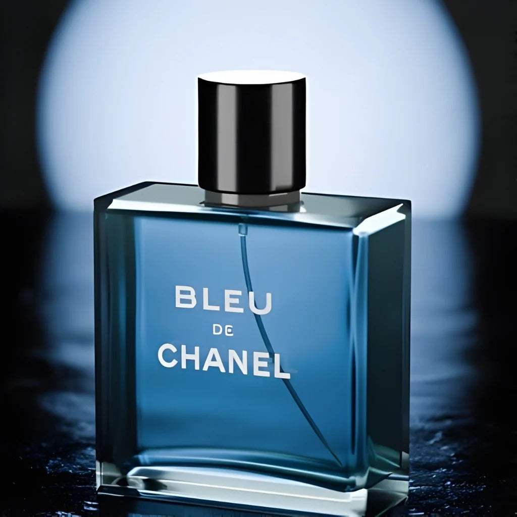 Bleu De Chanel blue glass bottle on dark reflective surface