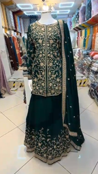 Dark green heavy embroidered sharara 3-piece with gold floral threadwork and dupatta – front view on mannequin